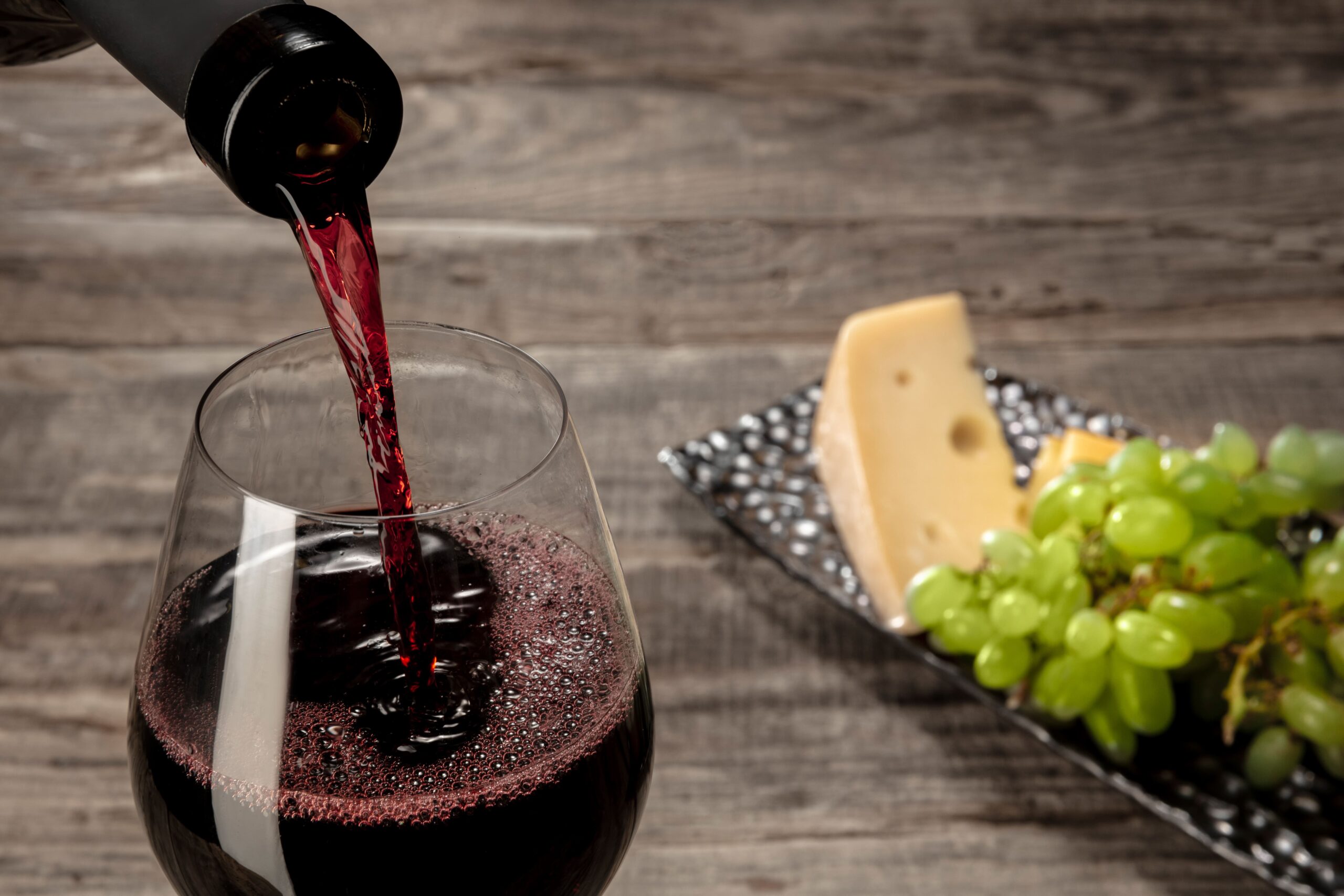 bottle-glass-red-wine-with-fruits-wooden-table